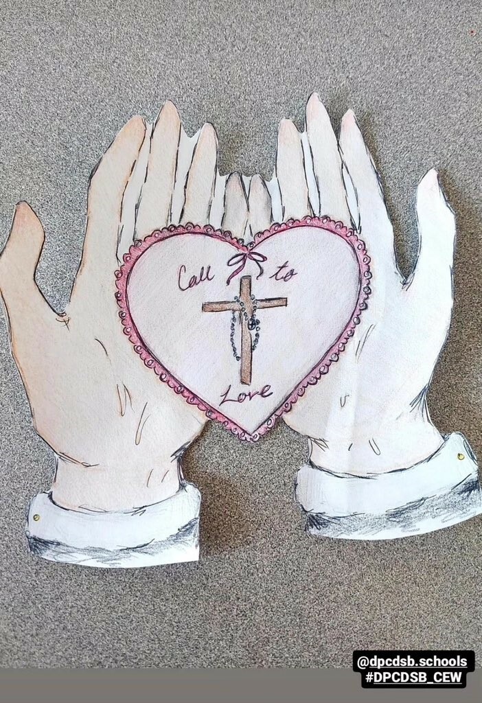 Picture of paper hands with a cross and heart in the middle