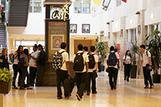a group of high school students walking in a school hallway
