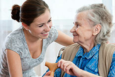 a woman greeting an elderly woman